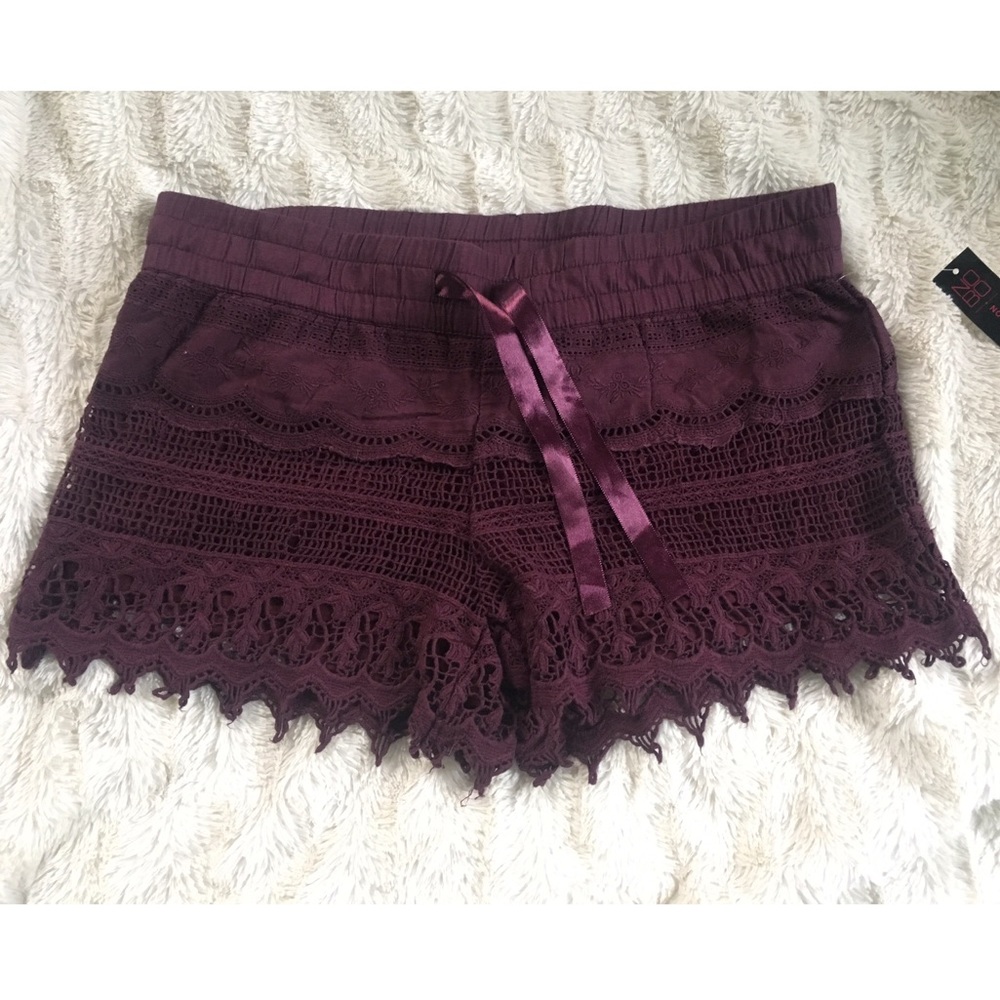 Netted style shorts with satin waist belt.